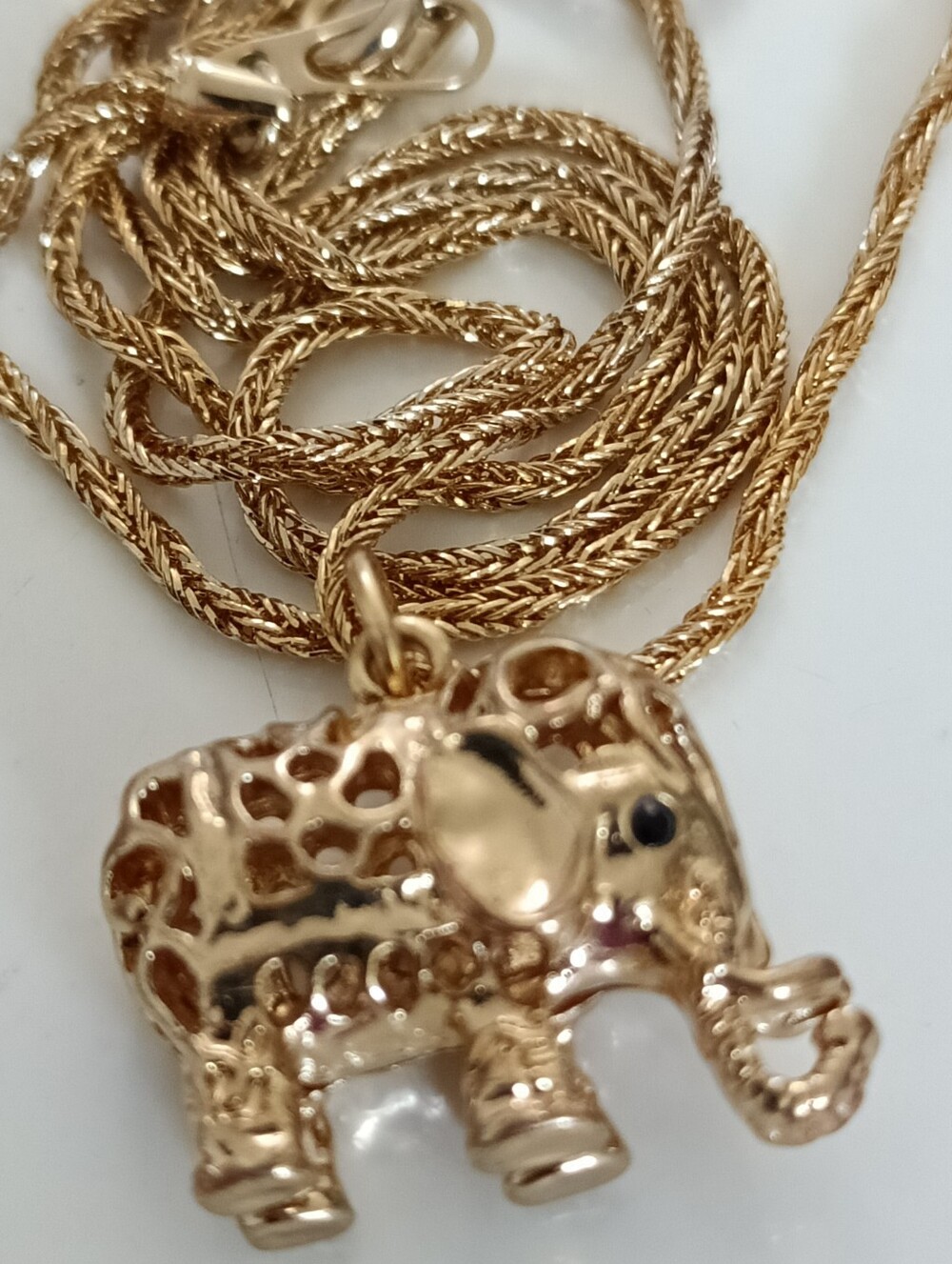 Goldtone filigree elephant pendant on a twisted goldtone chain